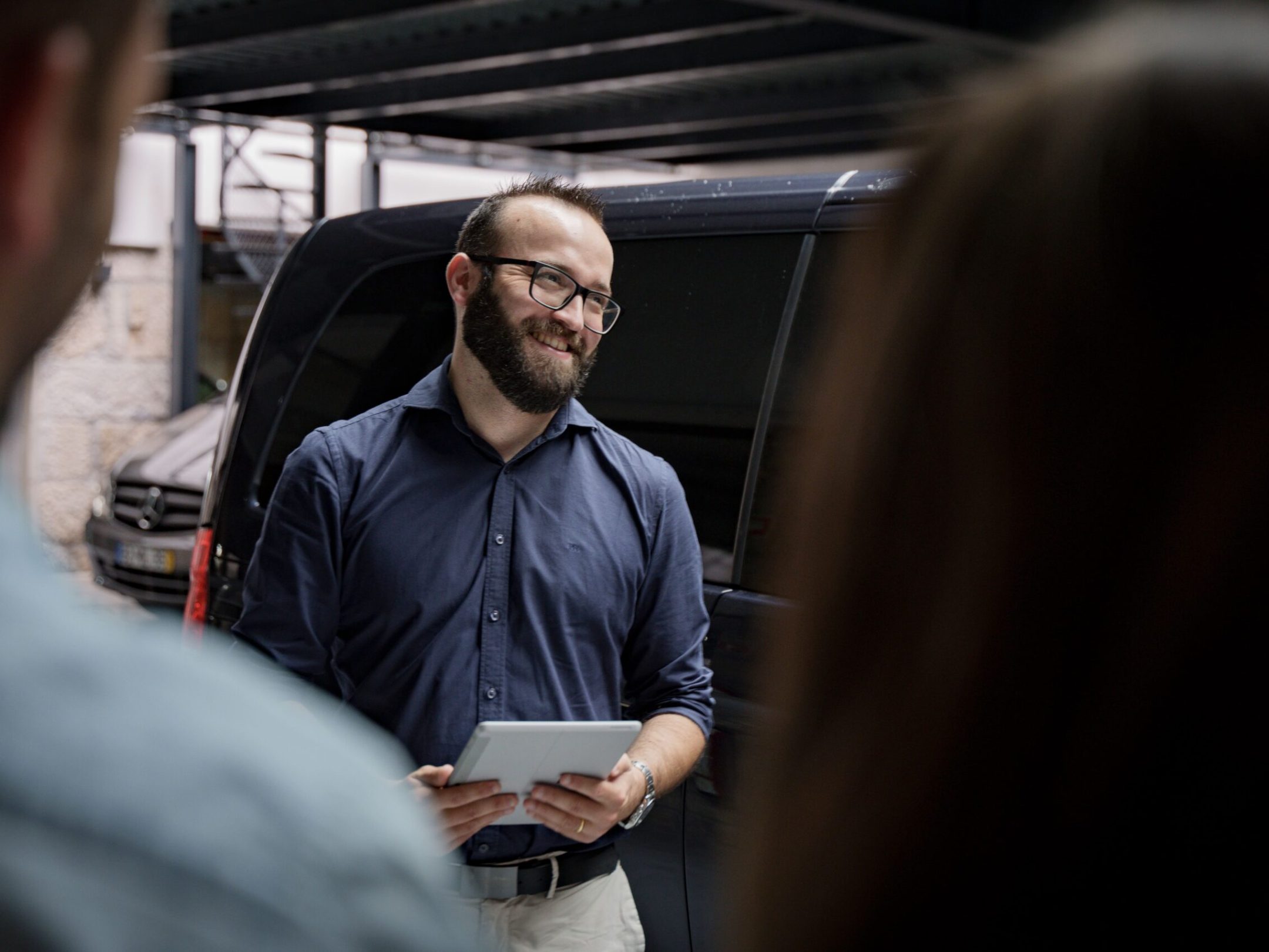 a man sitting in front of a van tour