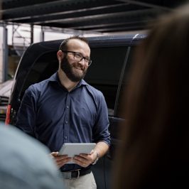 a man sitting in front of a van tour