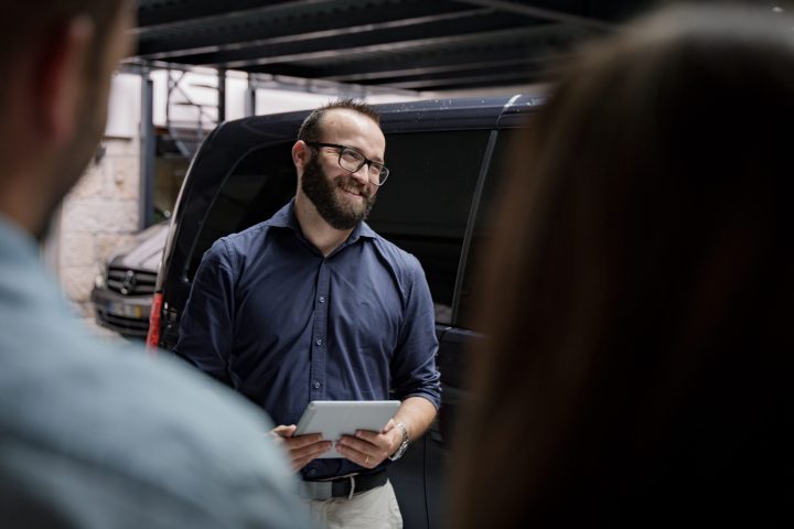 a man sitting in front of a van tour