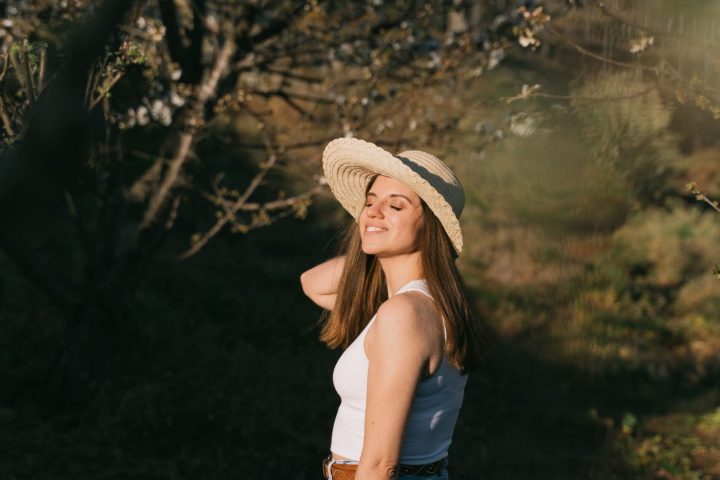 a person standing next to a tree