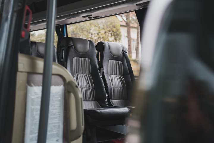 Interior of a vehicle showing empty black leather seats.