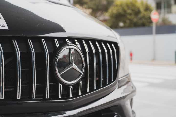 Close-up of a black car grille with a Mercedes-Benz logo.