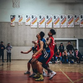 a group of people standing on a basketball court