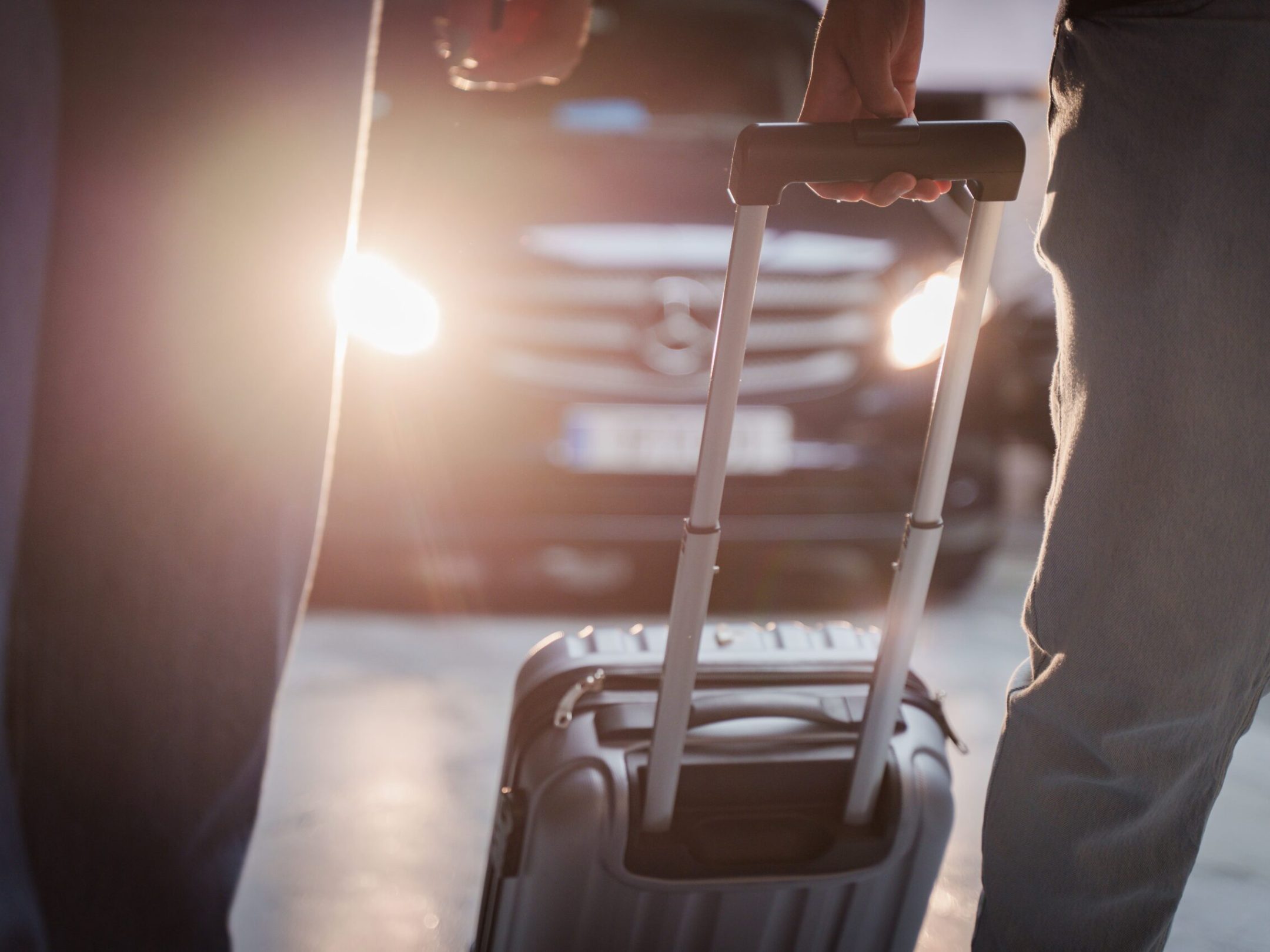 a person holding a luggage leving their transfer