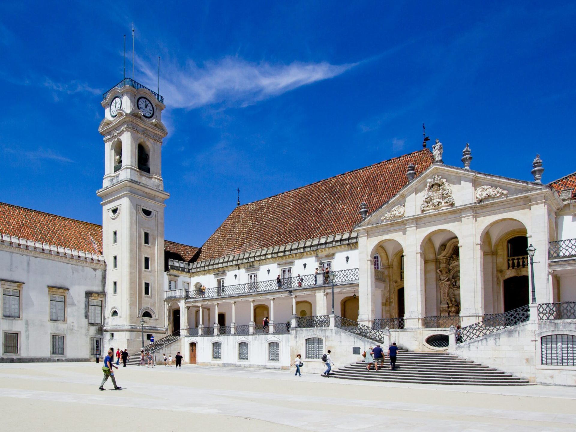 a group of people walking in front of a building