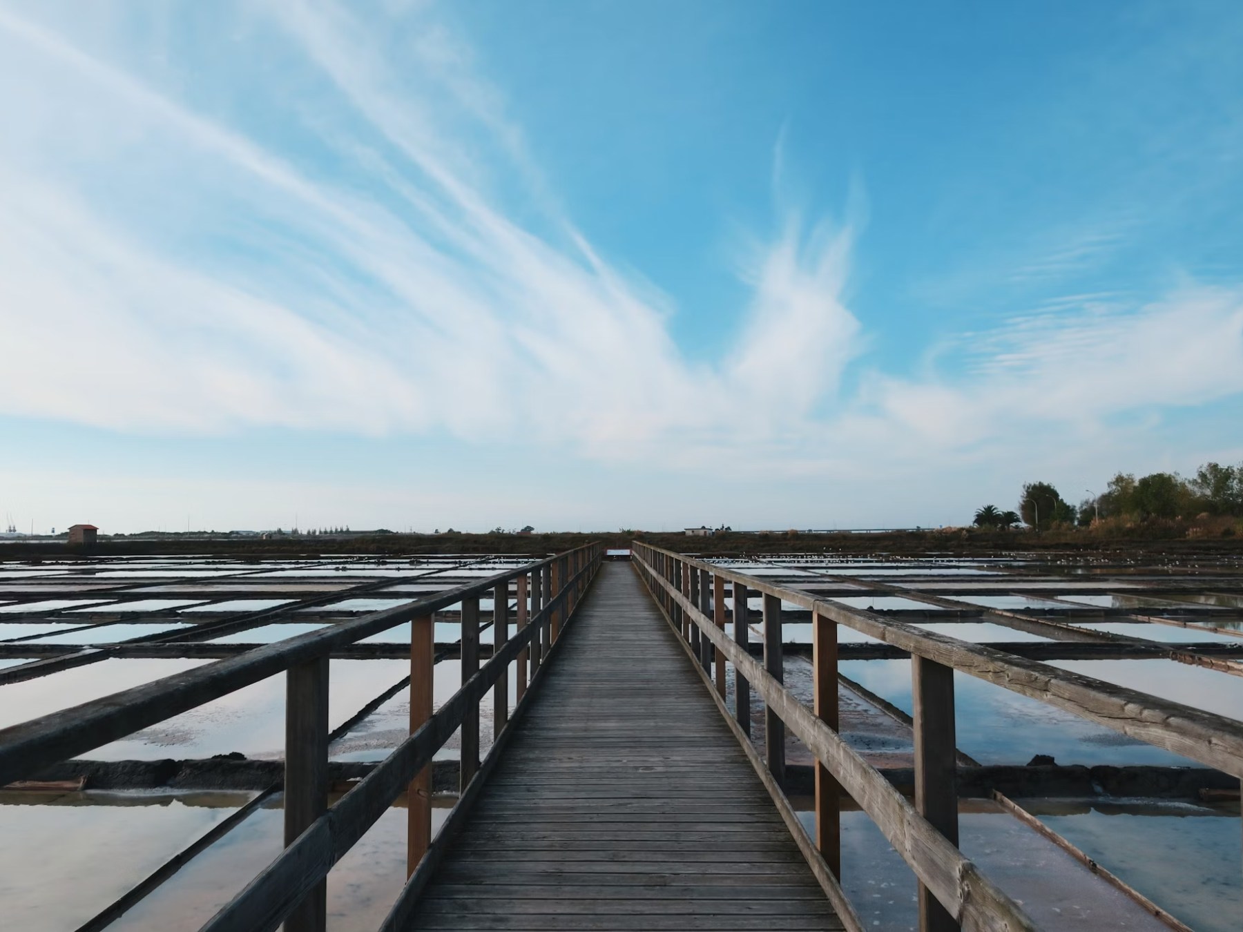 a wooden pier next to a body of water
